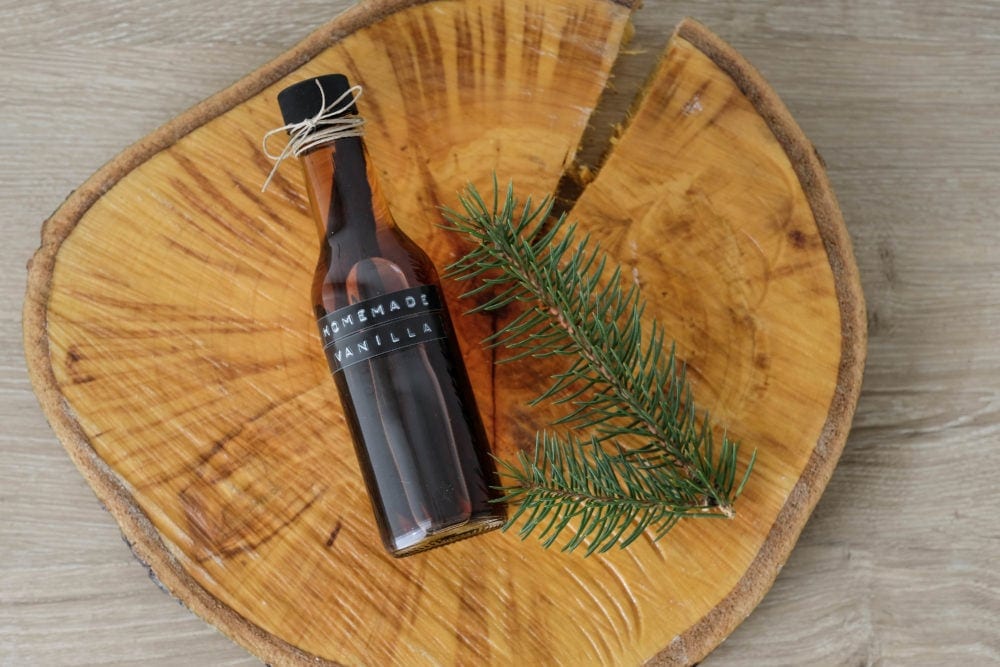 Homemade Vanilla Extract next to pine needles