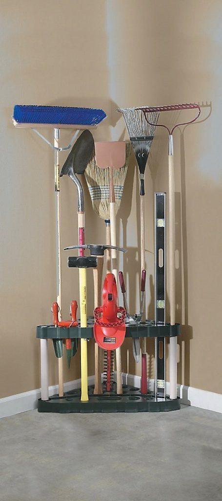 Cheap organization products including a collection of shovels, brooms, and various yard tools organized in a corner using a rubbermaid corner organizer