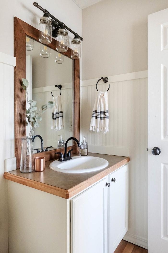  farmhouse bathroom with wood mirror frame