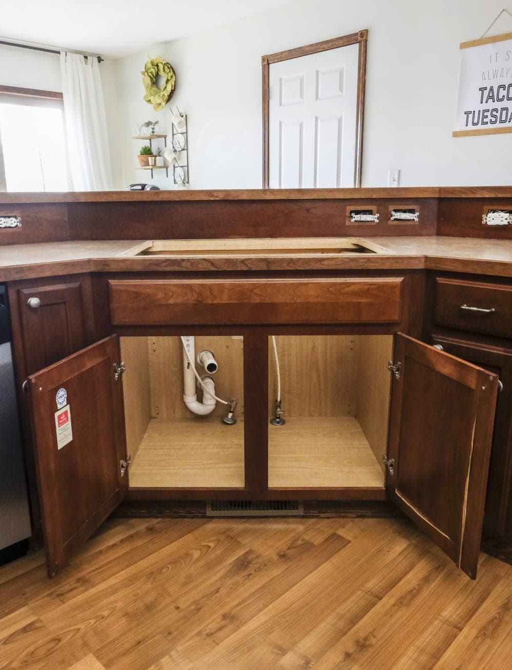 Kitchen cabinets with doors opened and sink removed