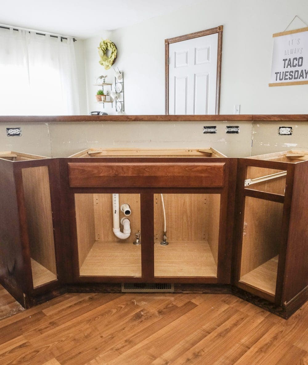 Kitchen cabinets with doors and counter tops removed ready for farmhouse sink install