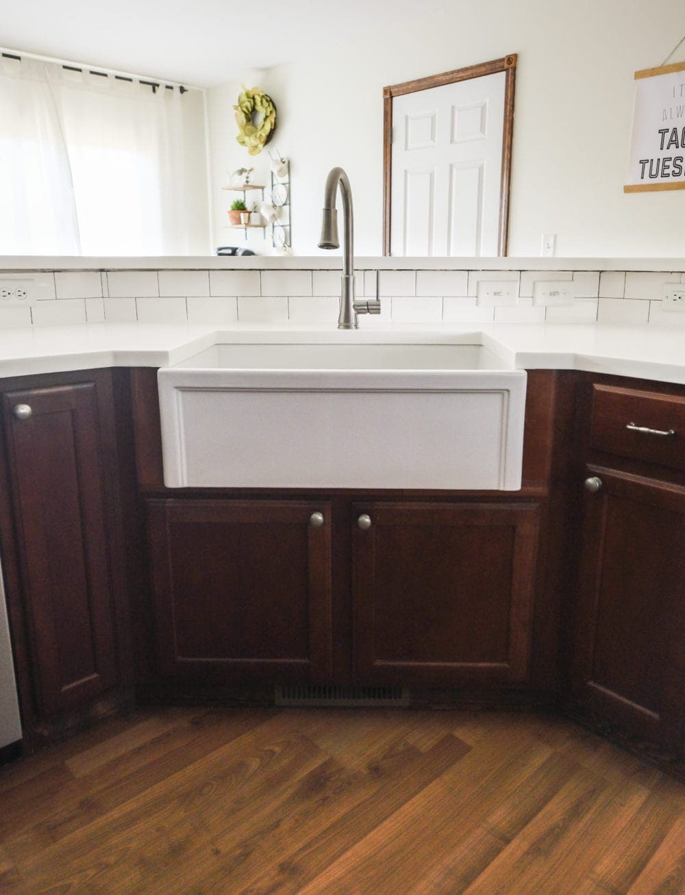 Kitchen with white countertops and wood cabinets with a farmhouse sink