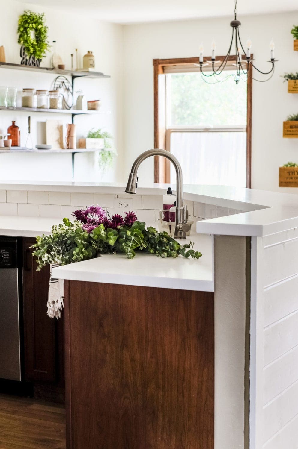 kitchen renovation after picture showing the white countertops and new Pfisher faucet 