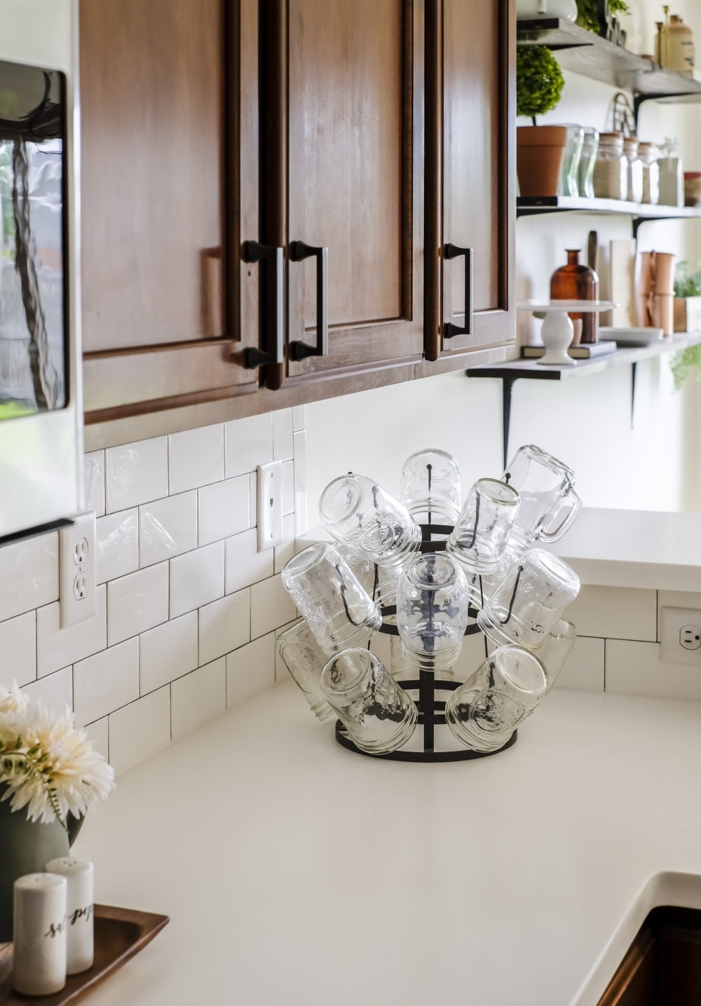 white solid surface countertops with mason jar glasses on a cup holder