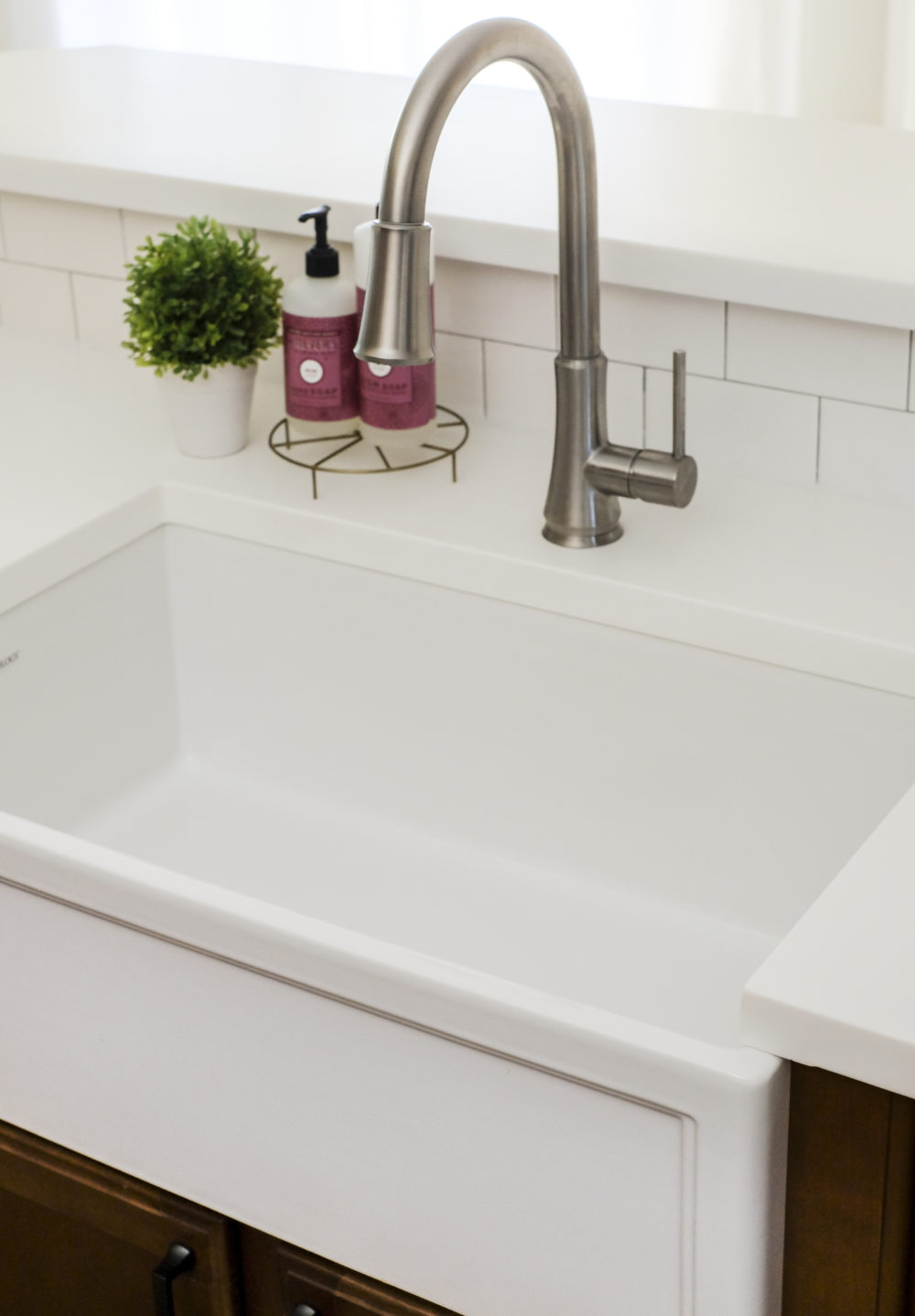 A closeup look at a white fireclay farmhouse sink