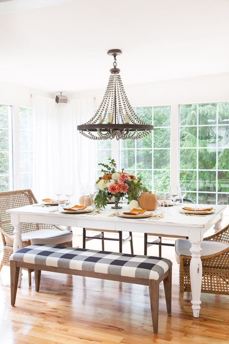 Thanksgiving table centerpieces with a simple floral arrangement in middle and place settings all around