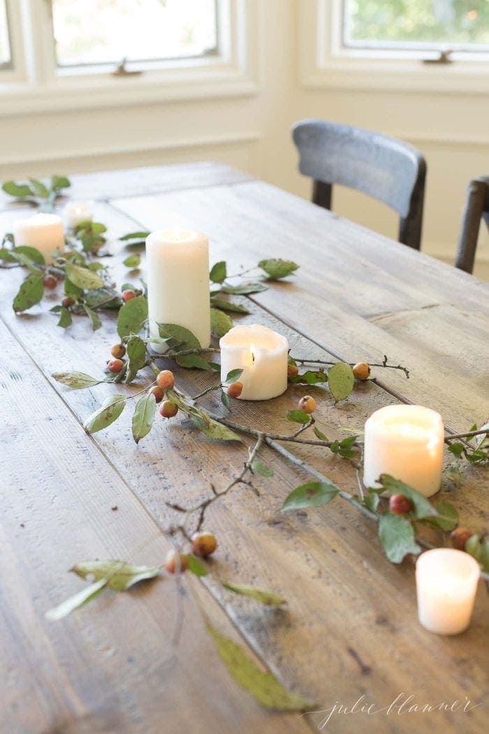 Thanksgiving table centerpieces using a simple runner made from branches and a few candles