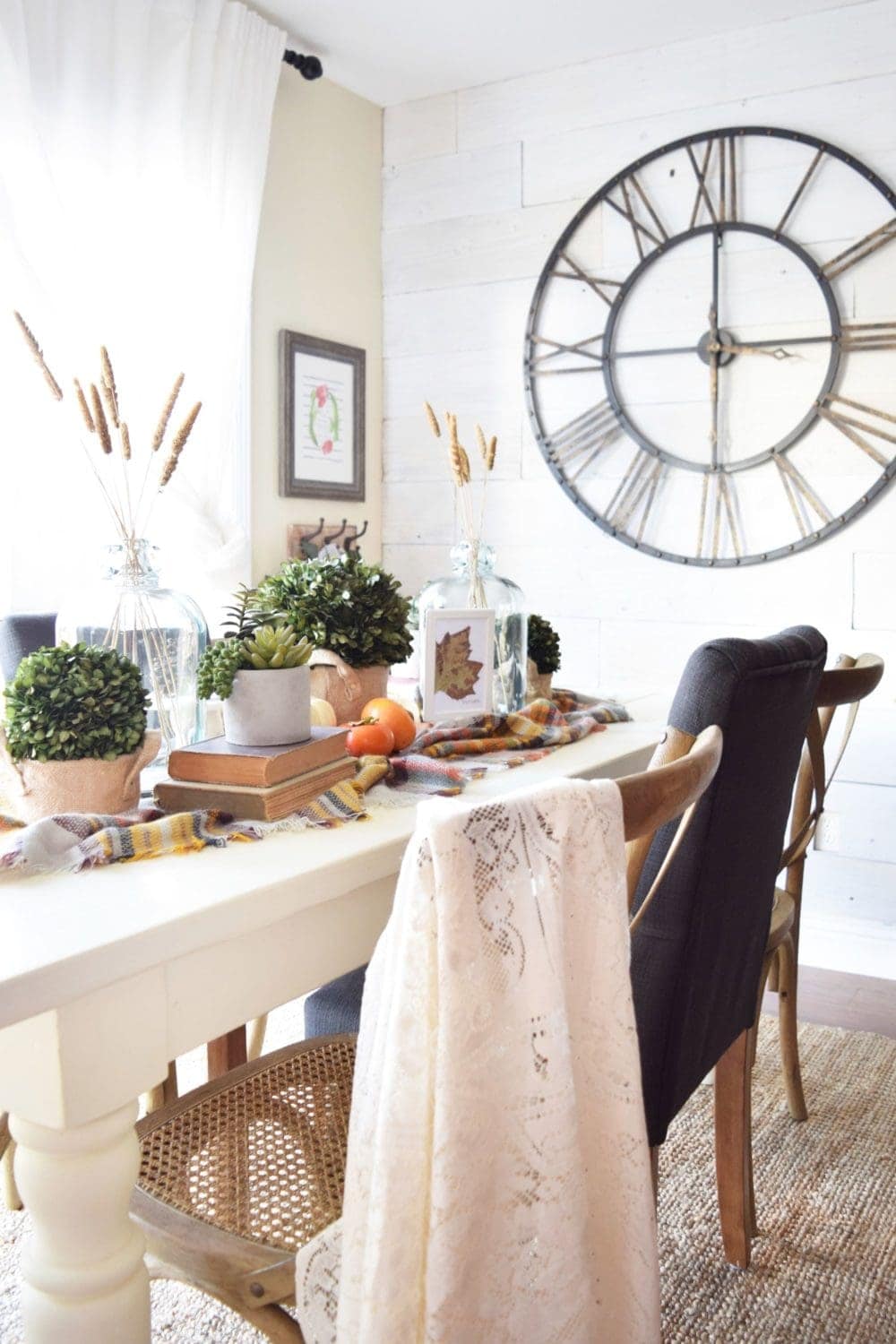 Thanksgiving table centerpieces with greenery and wheatstocks in vases