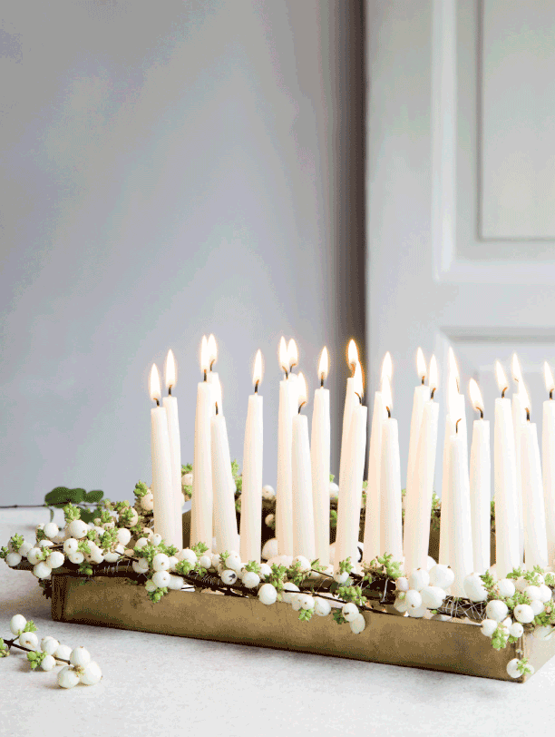 minimalist christmas decorations using a grouping of candles and a gold tray