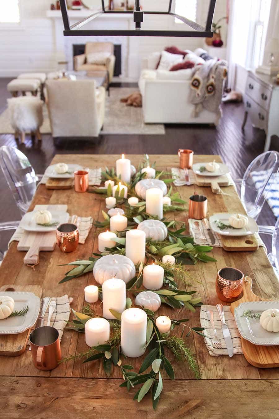 Thanksgiving table centerpieces with lots of candles and copper mugs