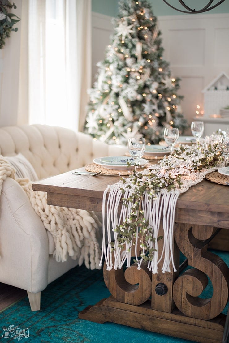 Christmas tablescape using a macrame table runner and a sofa as a bench seat