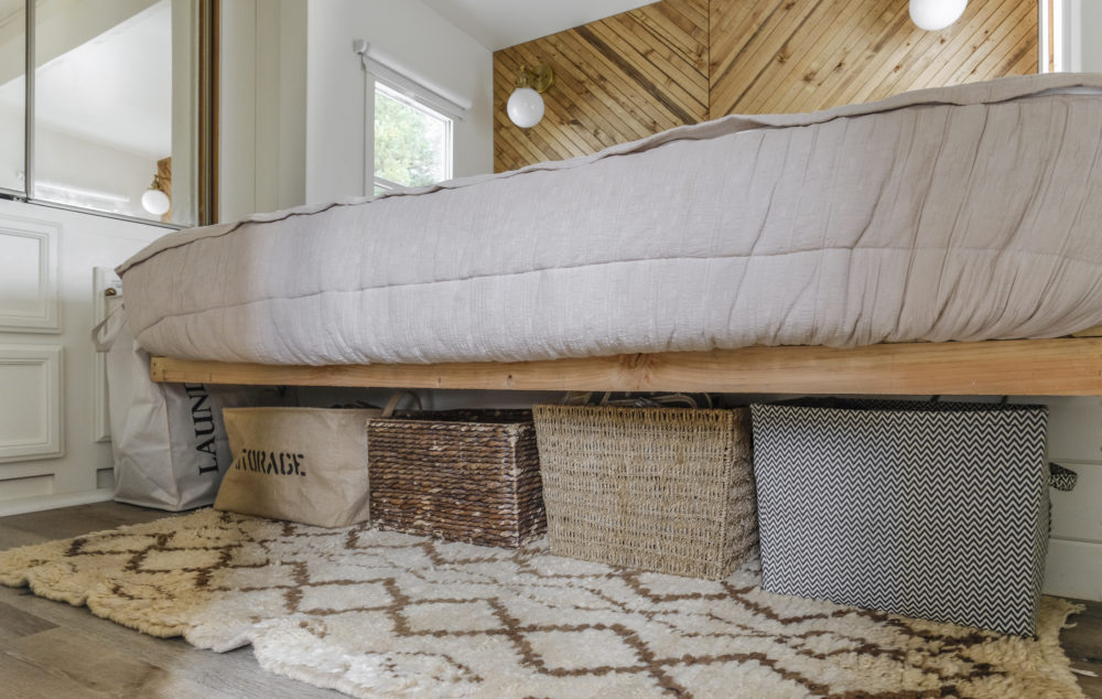 RV bed with baskets underneath for storage