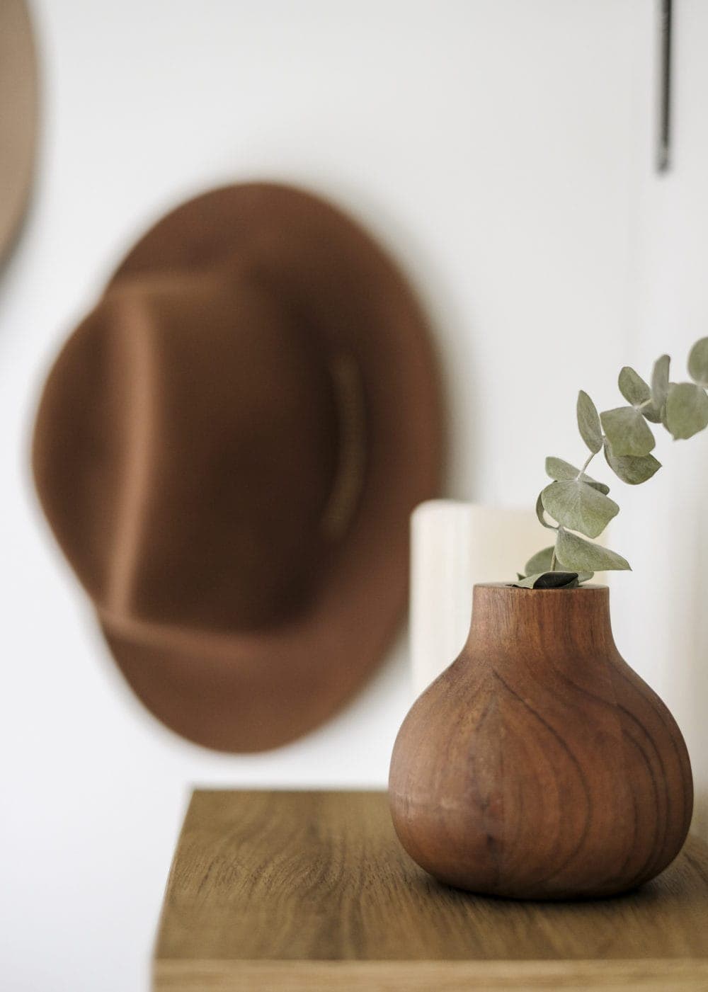 Small wood vase with eucalyptus in it