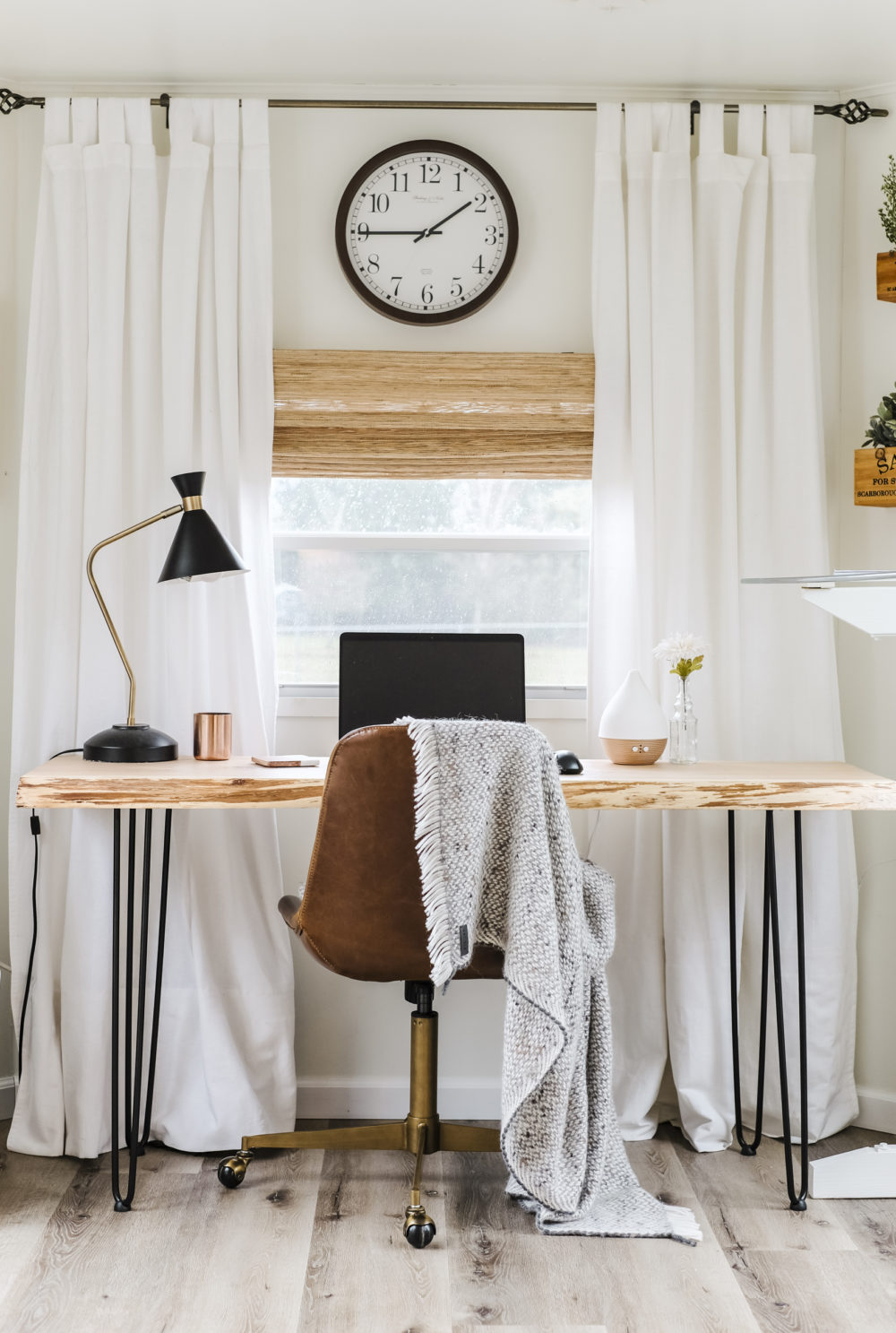 Closeup of home office with wood desk and leather office chair