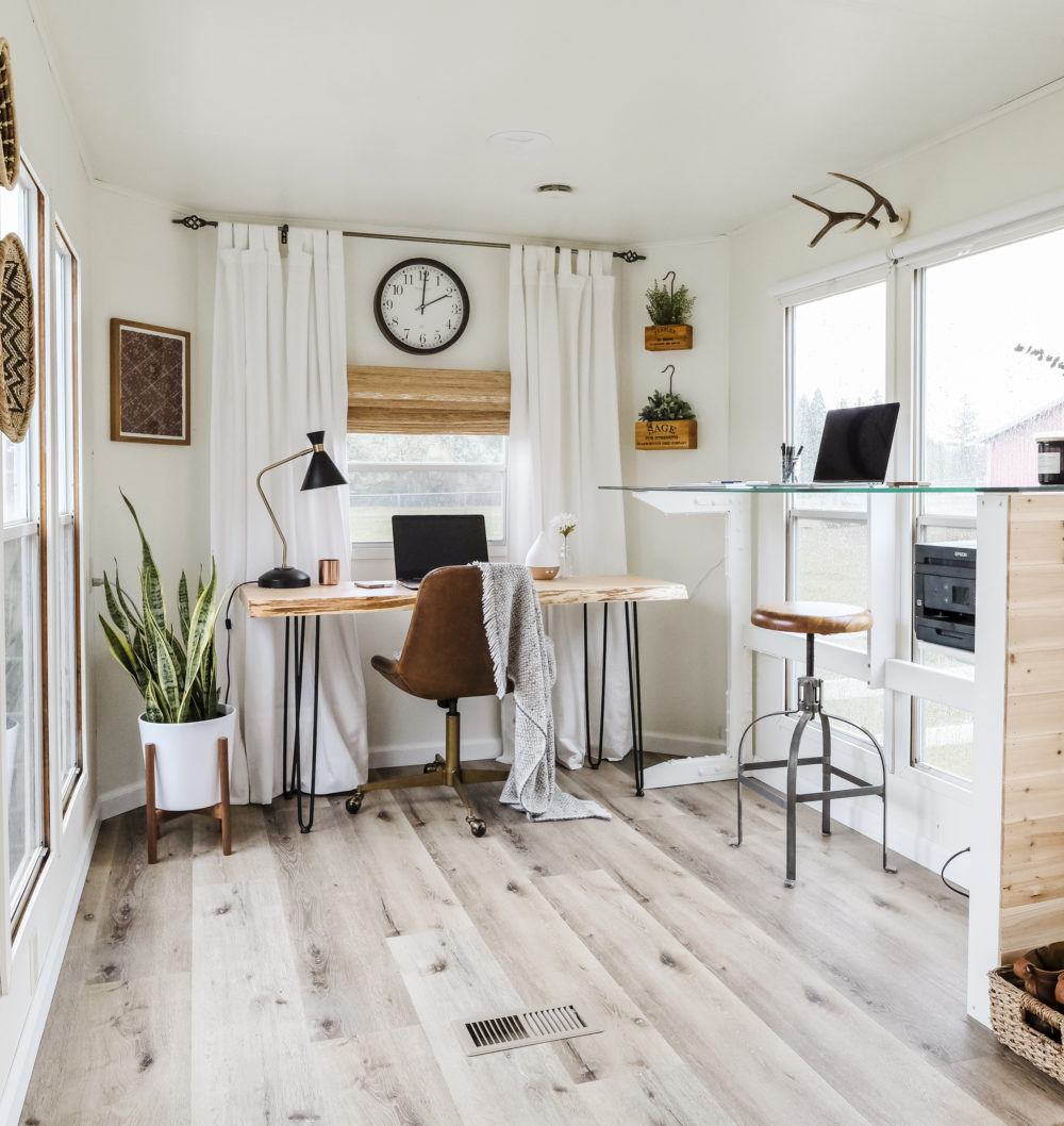 Small home office design with two desks and large windows