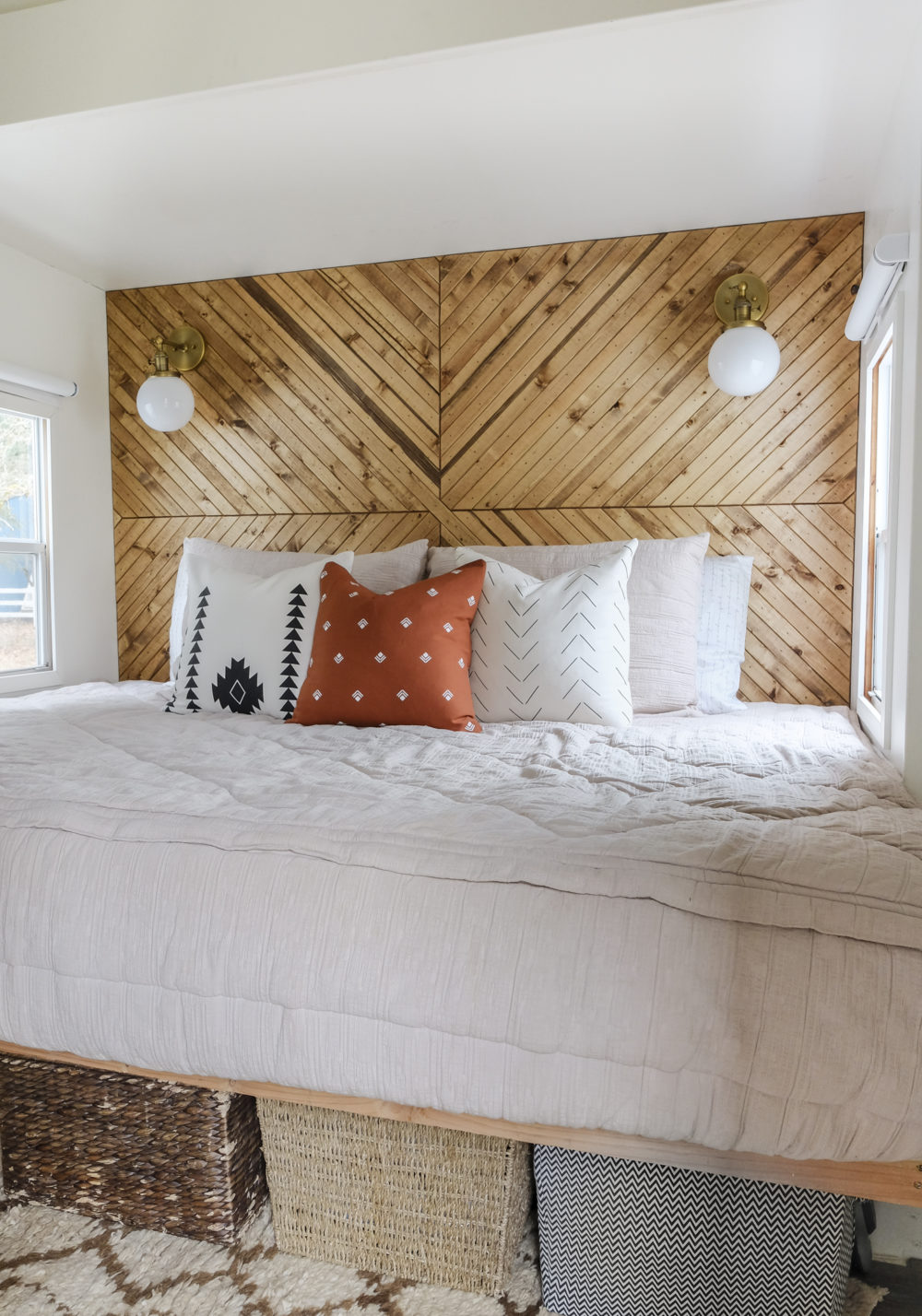 A small bedroom with a wood accent wall