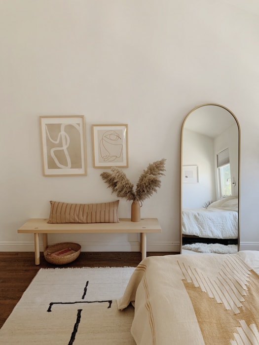 full length mirror leaning against the wall in a bedroom