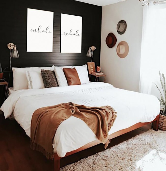 bedroom with black shiplap accent wall behind the bed