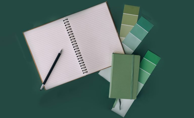 paint samples on a green desk showing the Best Green Paint Colors