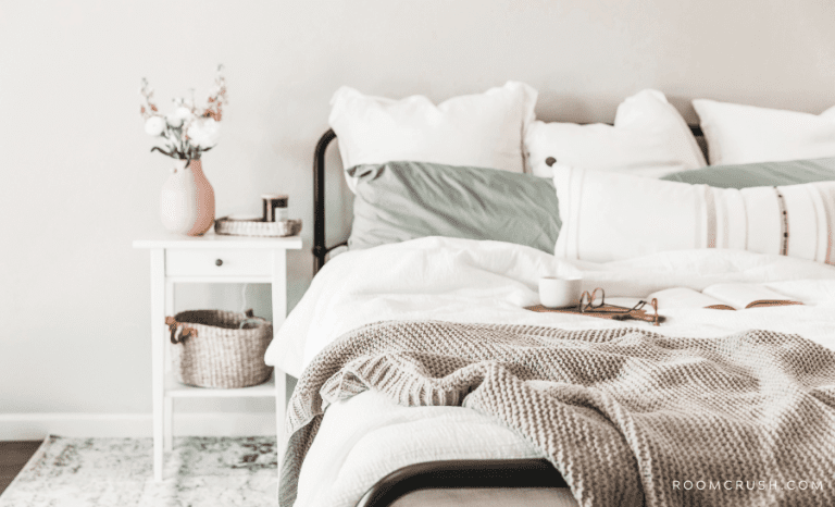 Bed and bedside table showing how to style a bed in a studio apartment