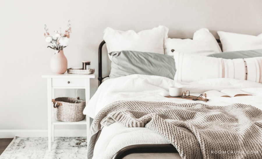 Bed and bedside table showing how to style a bed in a studio apartment