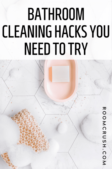 Soap suds and cleaning supplies on a bathroom floor showing the best bathroom cleaning hacks in action