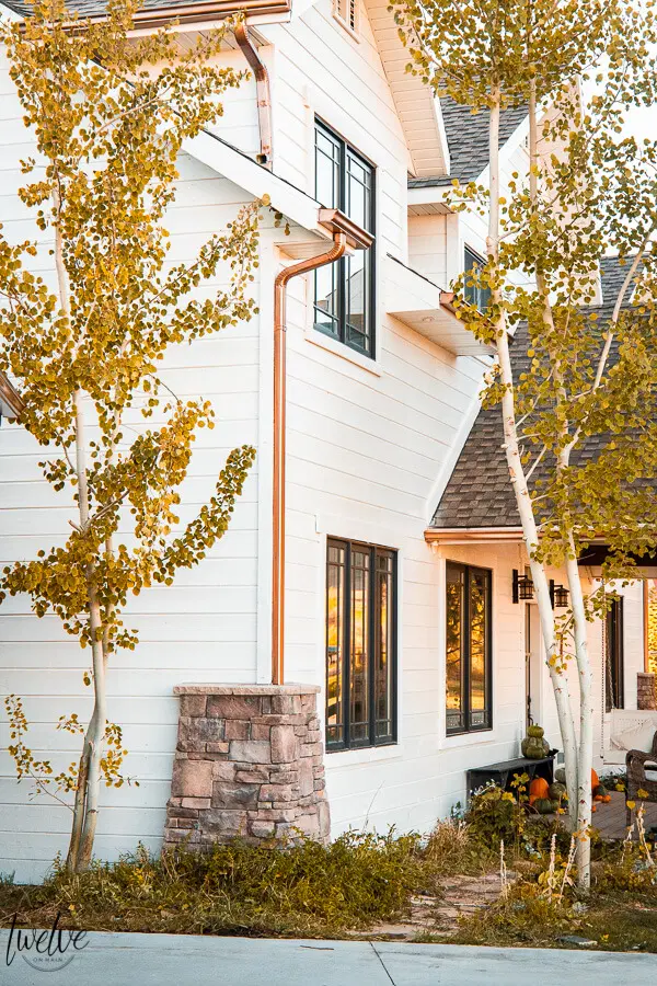 Exterior of a home painted with Benjamin Moore White Dove and copper gutters