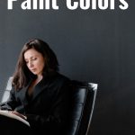 woman sits beside black wall, reading about the Best black paint colors: Ultimate guide